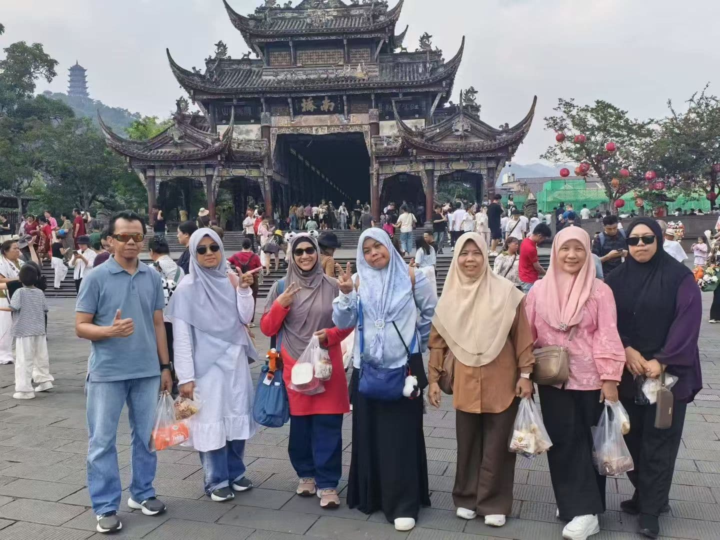 Travelers at a traditional gate in Yunnan