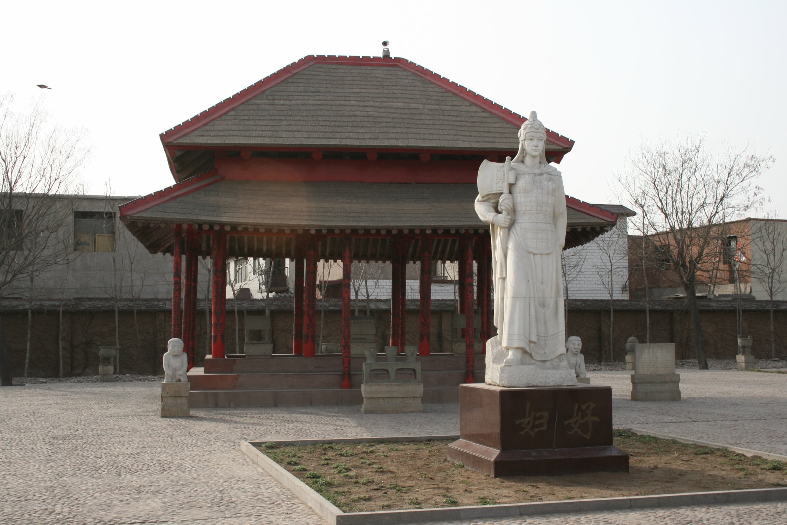 Modern statue of Fu Hao beside the protected tomb site