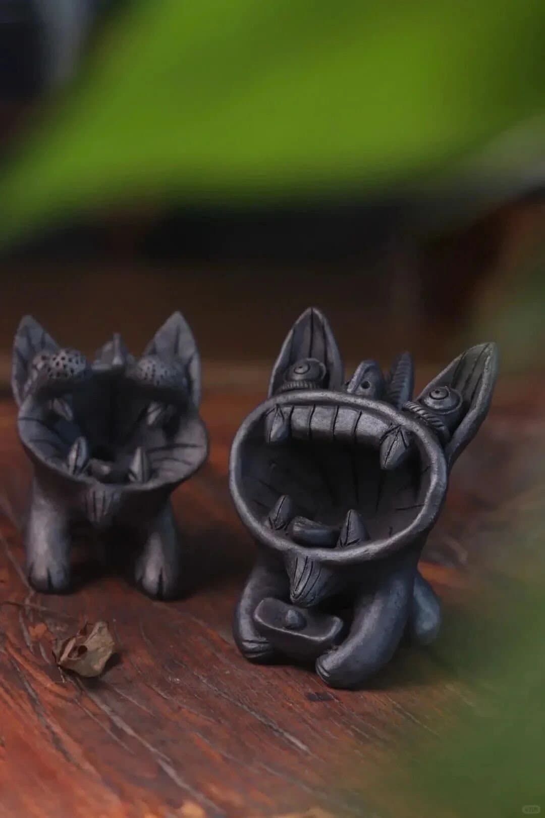 Tile Cats — black tile cat figures in a workshop
