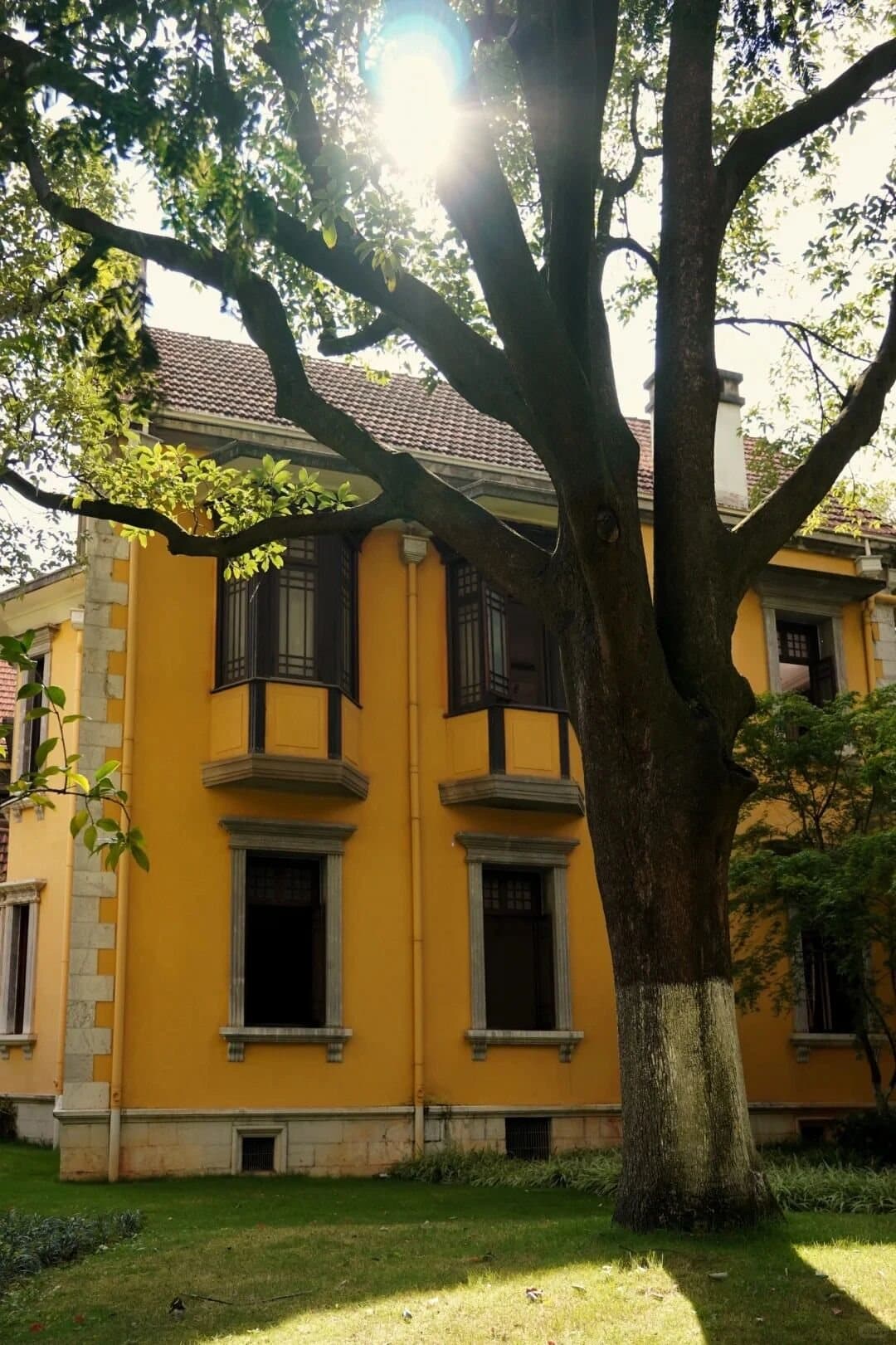 Green Lake Kunming — historic yellow buildings under mature trees