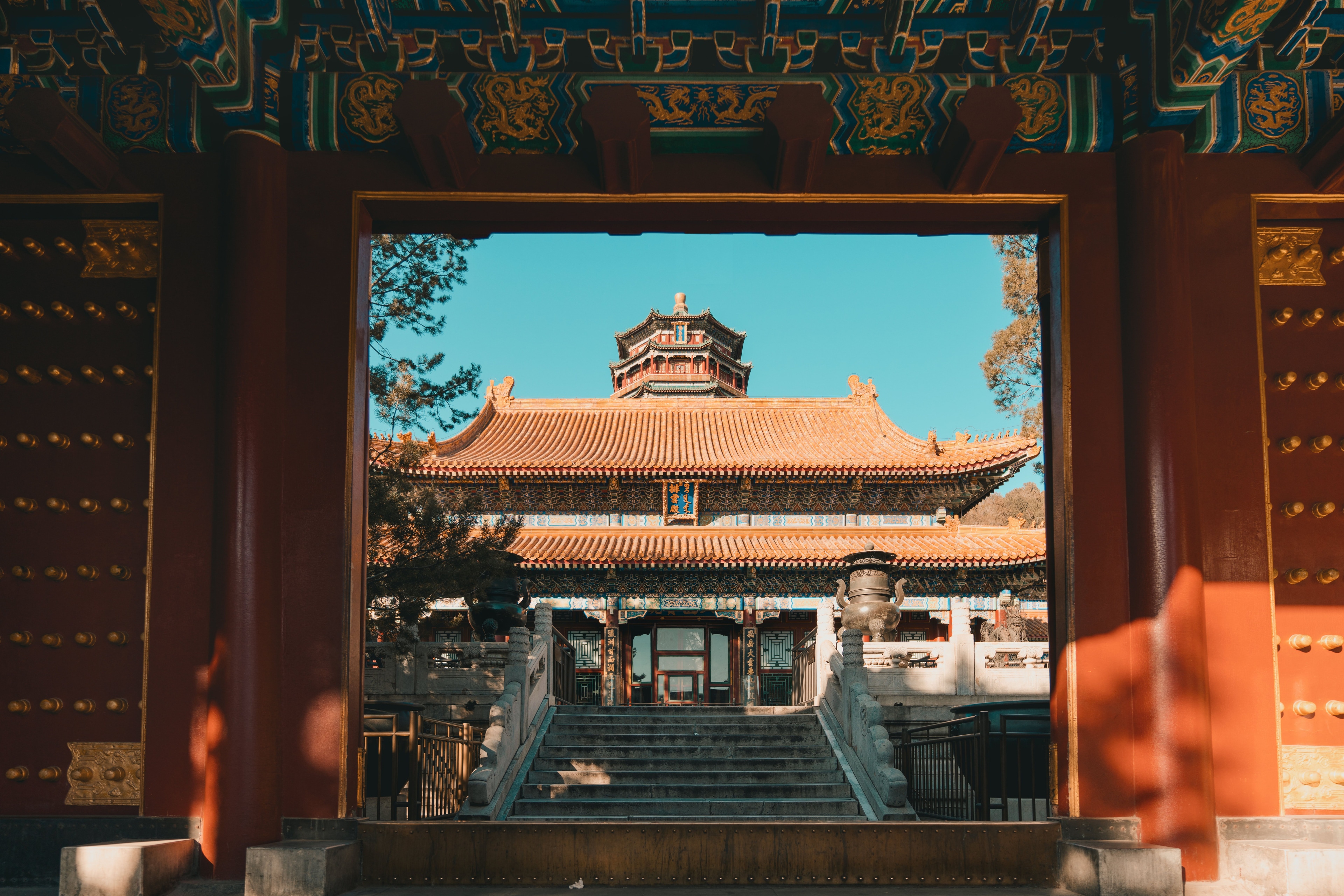 A Beijing pavilion framed by a traditional red gateway