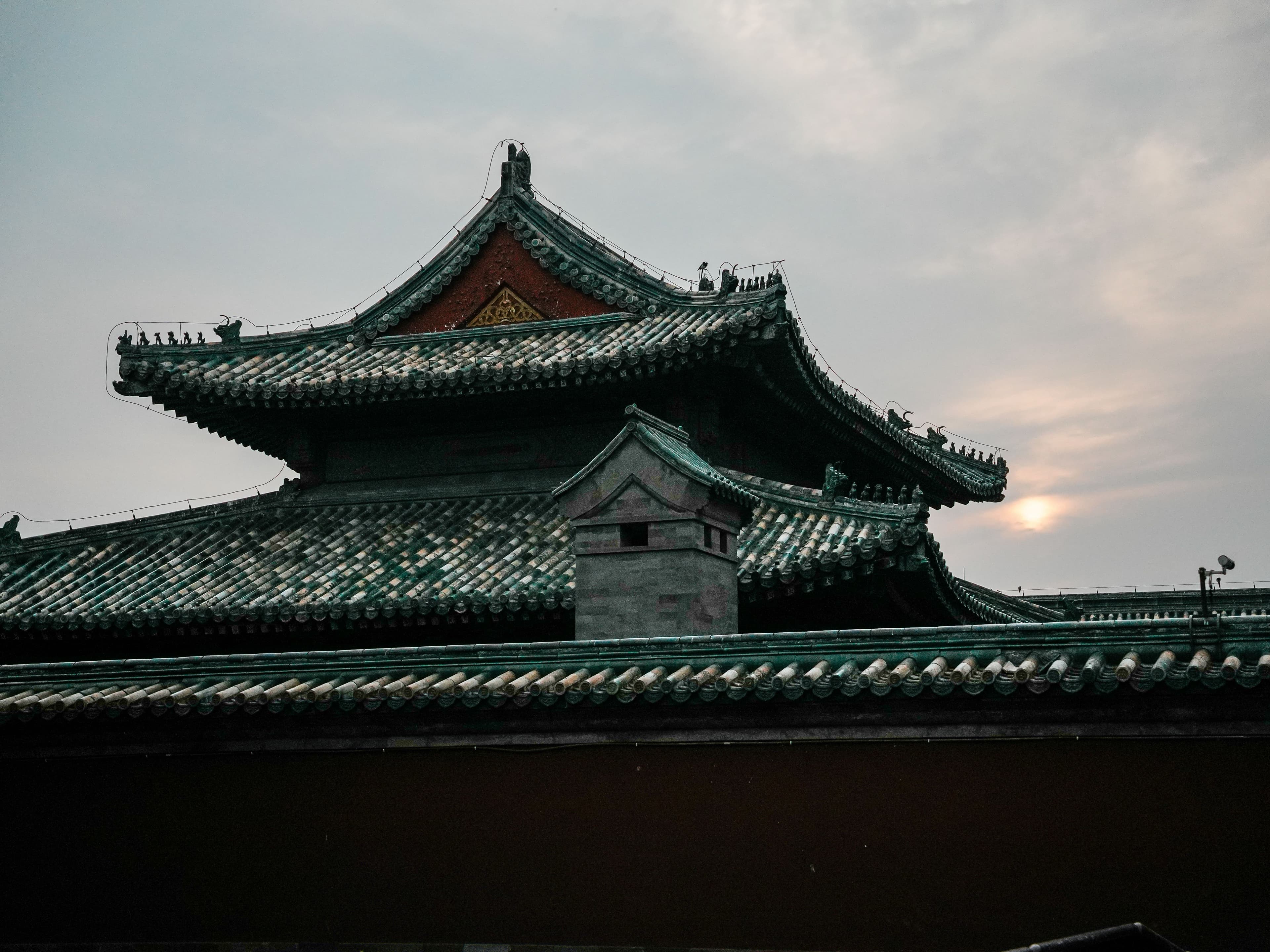 Historic Chinese rooftops beneath an evening sky