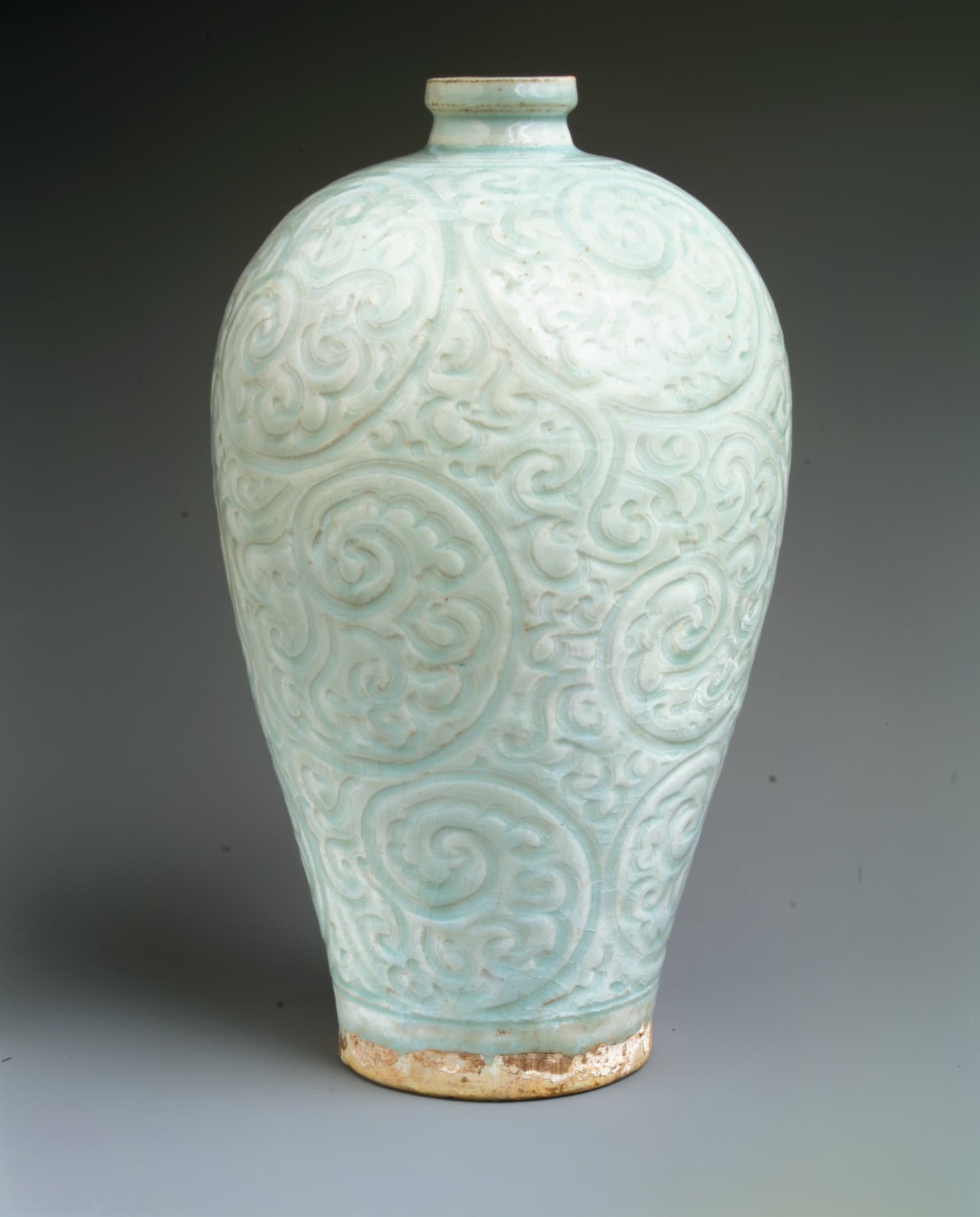 A pale bluish-white Jingdezhen qingbai bottle with carved vegetal scrolls