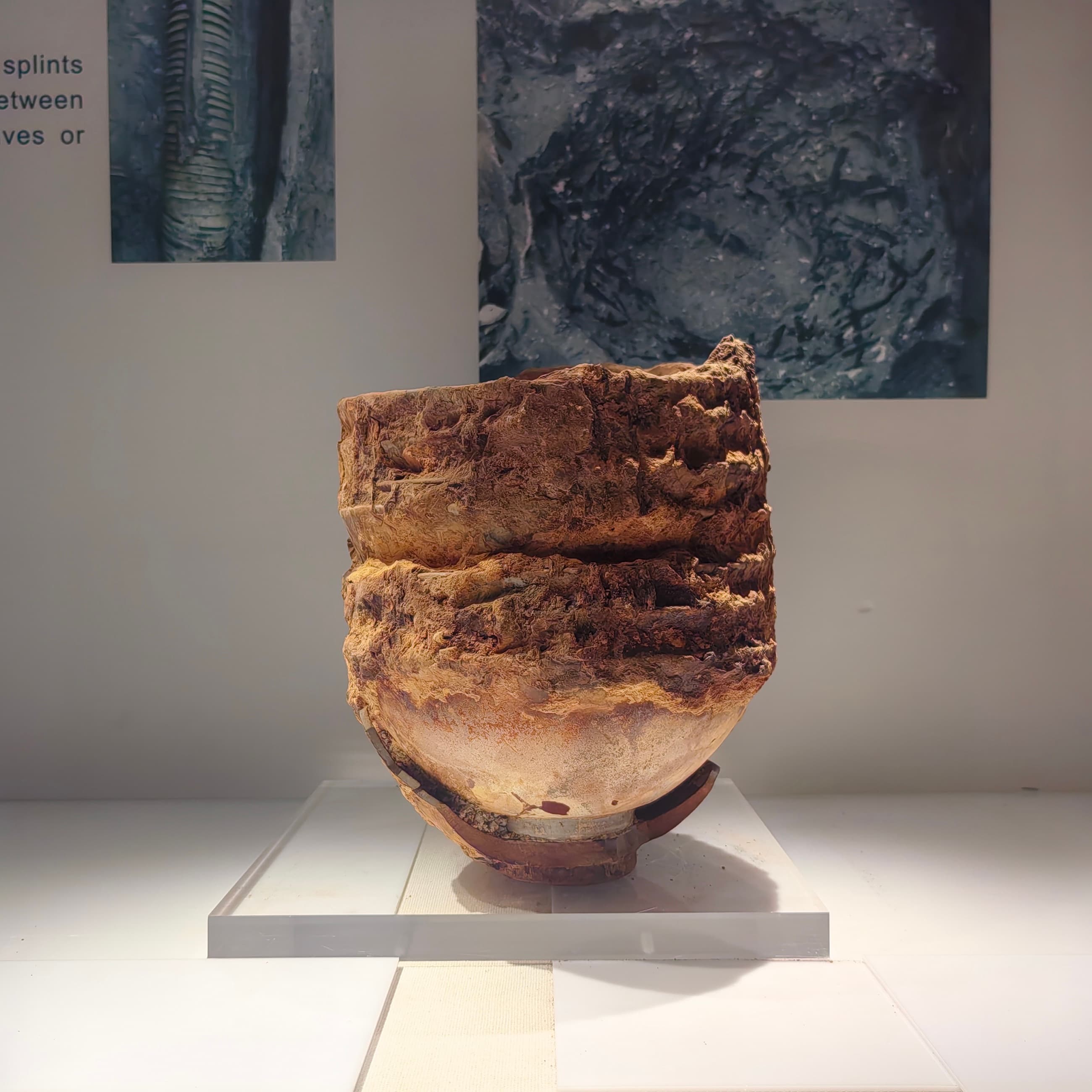 A concreted mass with a large jar packed around smaller ceramic vessels