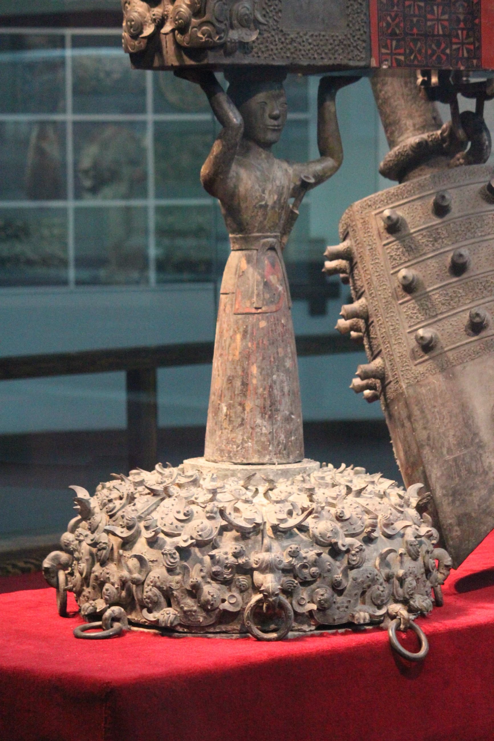 Detailed view of inscriptions and cast decoration on a bronze bell