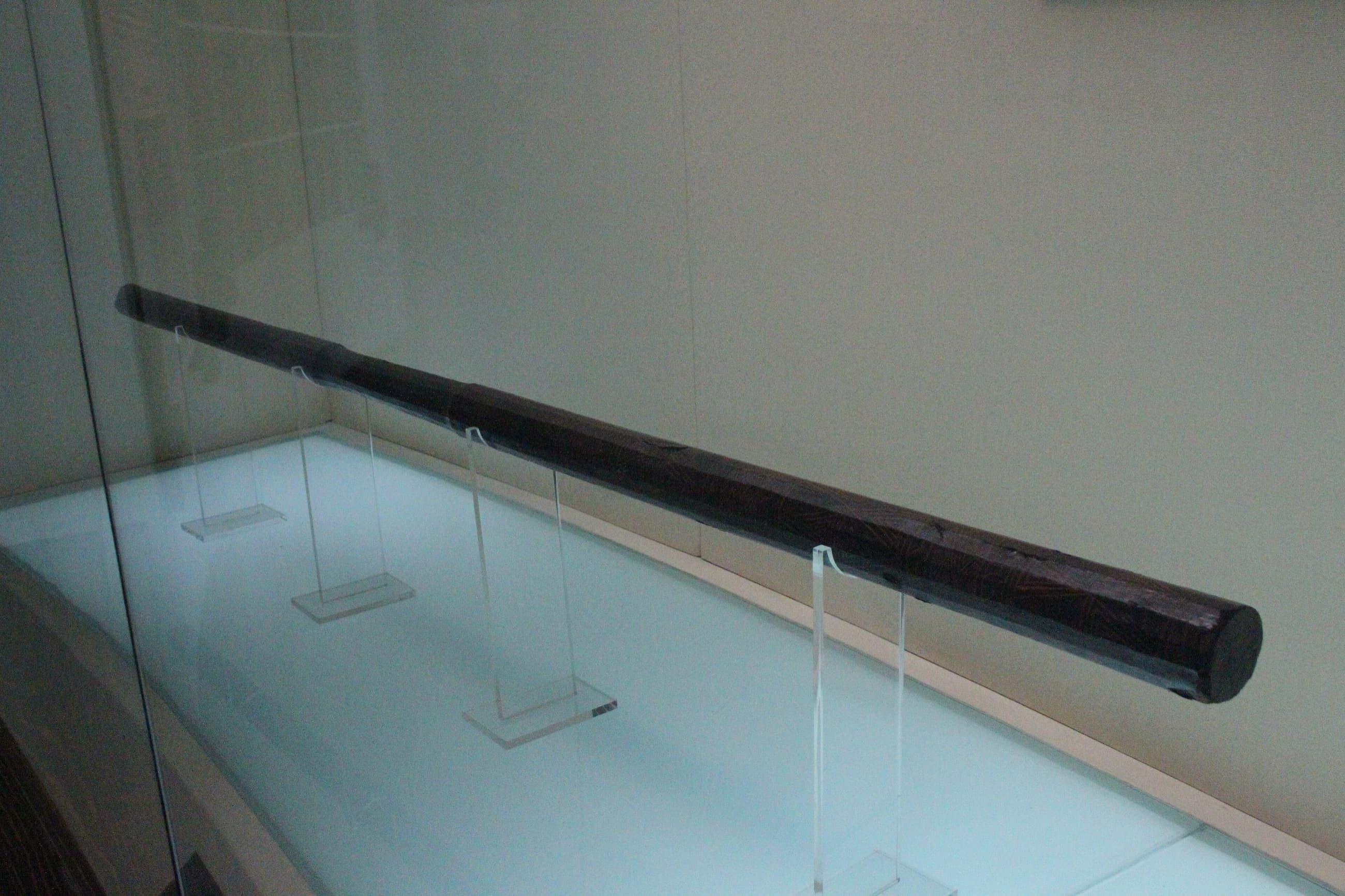 Lacquered wooden rod used for striking larger bells
