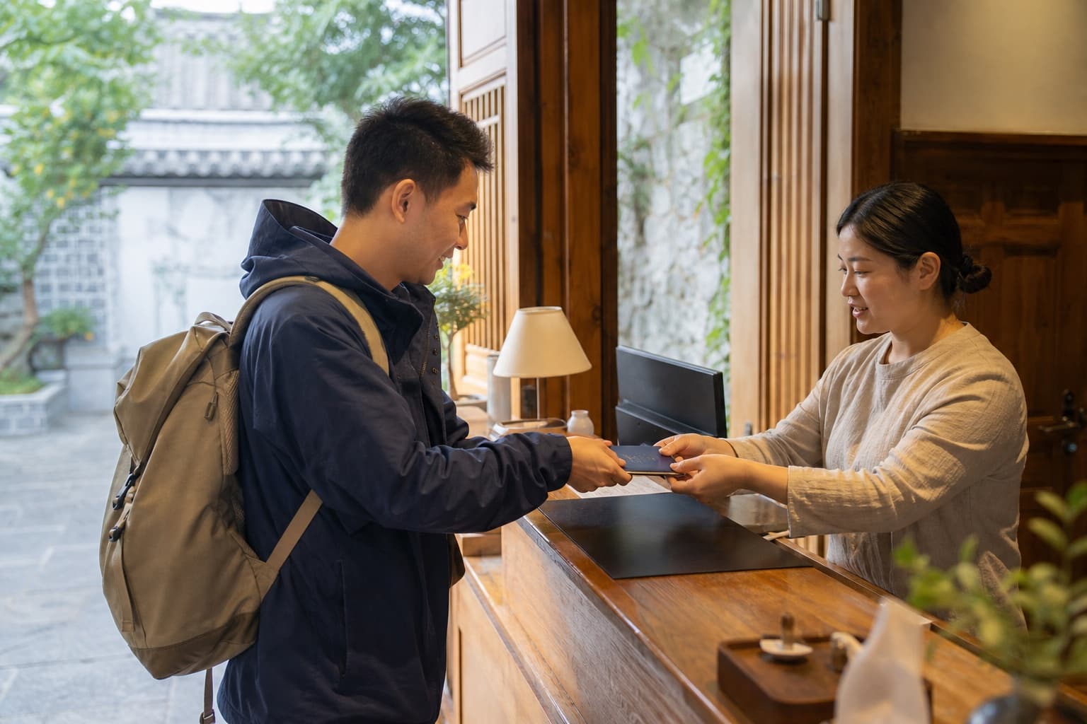 Traveler presenting a passport at a hotel reception in China